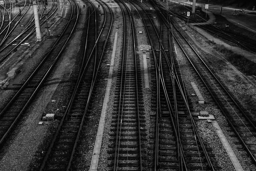 Black and white photo of converging rail tracks
