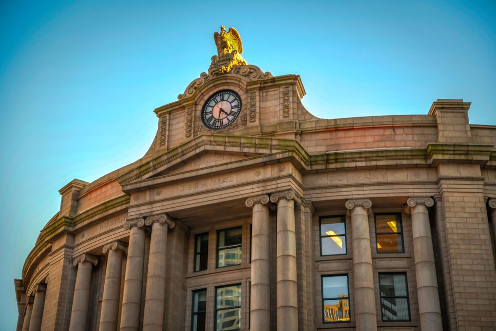 Clock and gilded eagle atop Boston South Station's terminal facade