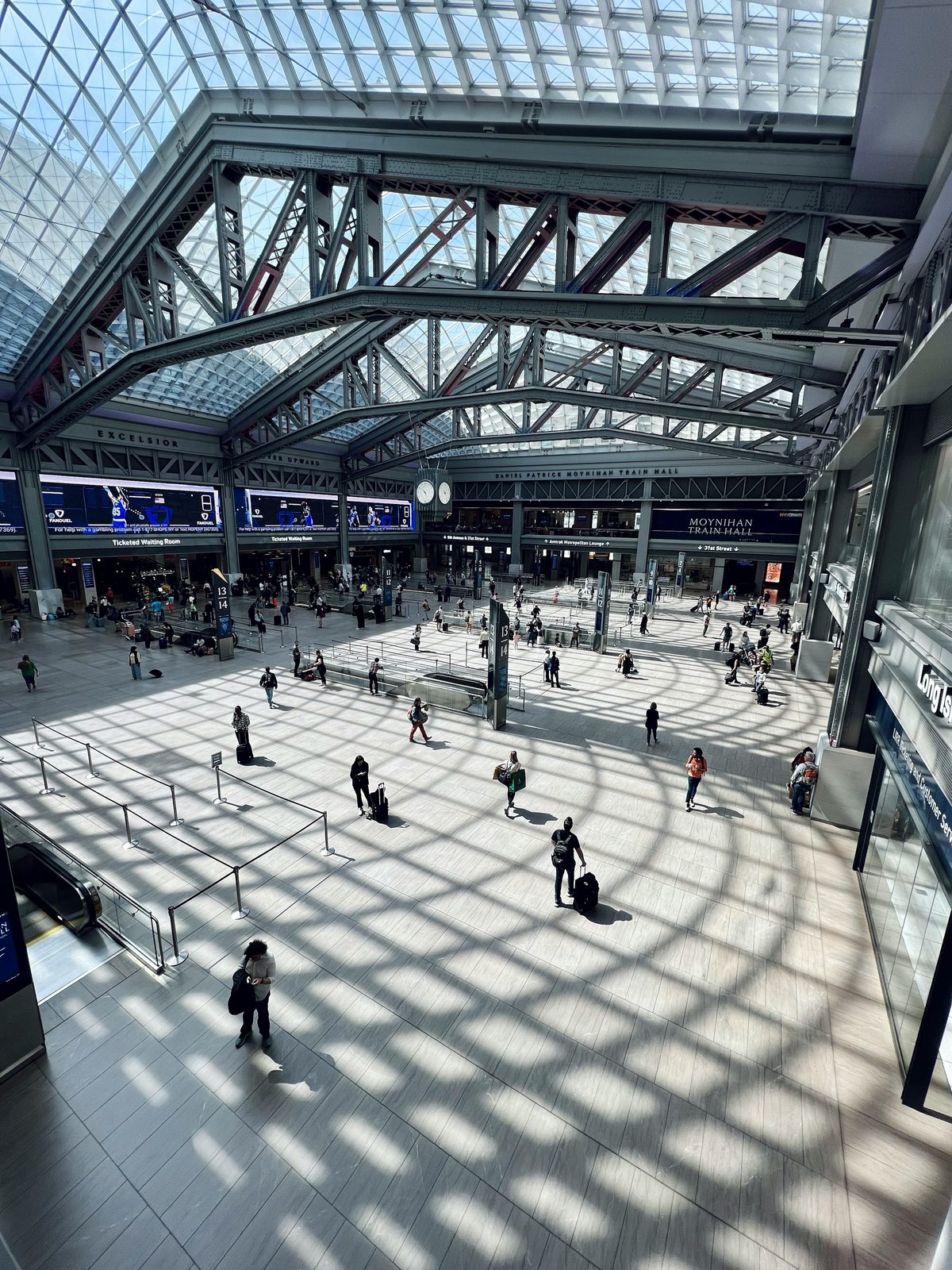 Steel and glass roof trusses inside Moynihan Train Hall at New York Penn Station